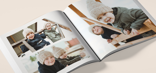 Closed photobook showing photos of a son and father on the cover that reads 'my dad is my superhero'.