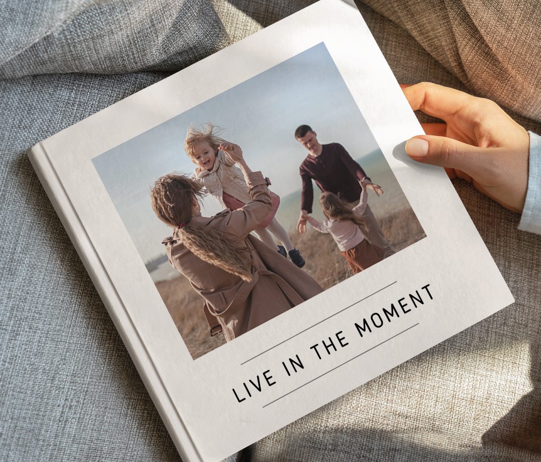 Two photobooks stack on top of each other with a photo of a man looking over the ocean on the front with the text Norway 2024'