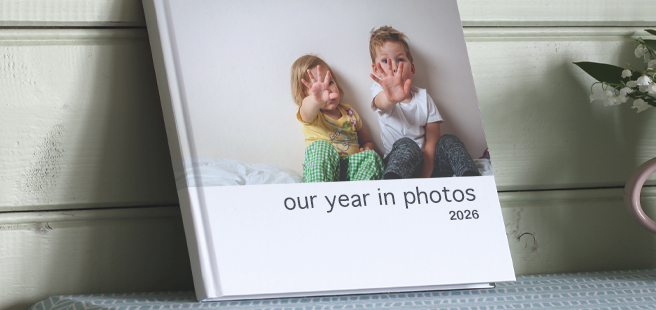 Closed photobook showing photos of a son and father on the cover that reads 'my dad is my superhero'.