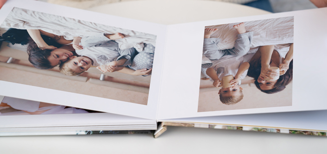 Closed photobook showing photos of a son and father on the cover that reads 'my dad is my superhero'.